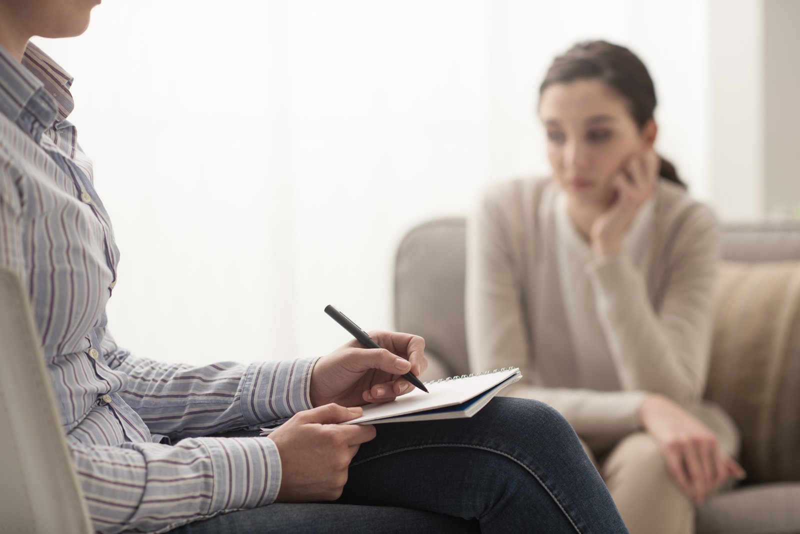 woman sitting in psychology session with her therapist