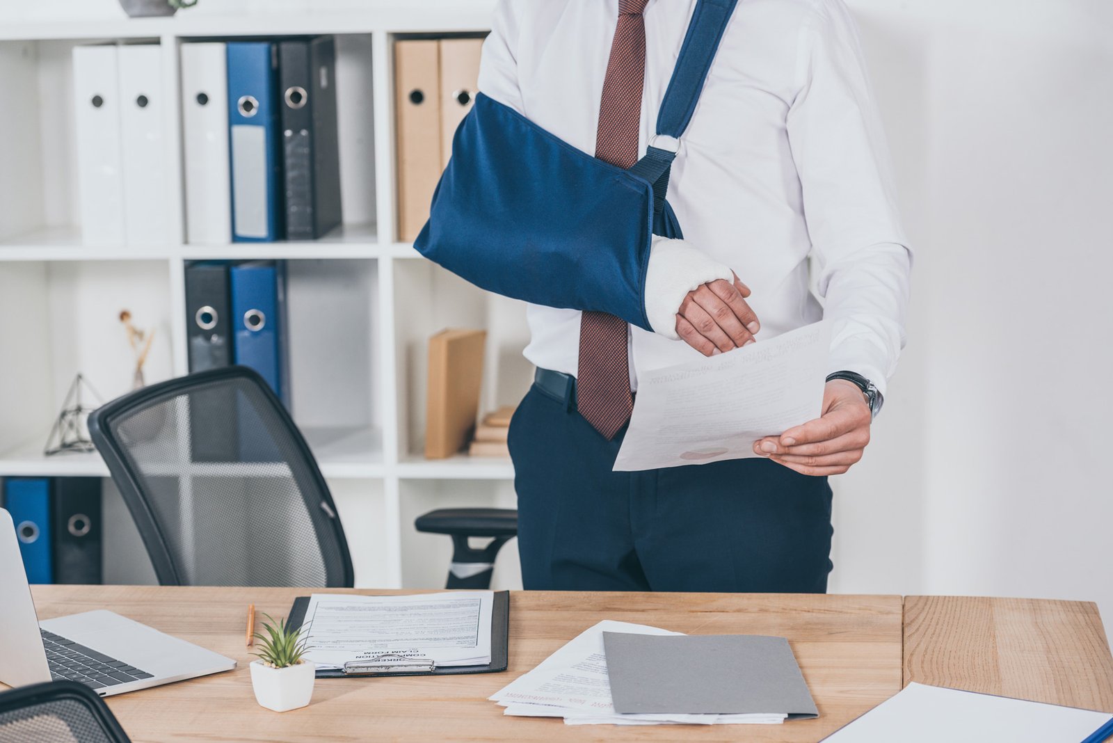 man with injured arm reading documents